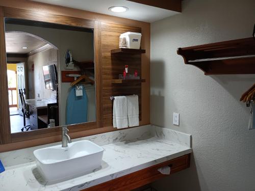 baño con lavabo y espejo grande en Americas Best Value Inn & Suites-Alvin/Houston, en Alvin