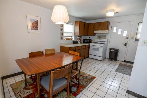 a kitchen with a wooden table and a dining room at Southwest Charming Apartment - Amazing View in Pittsburgh