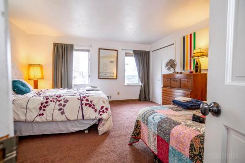 a bedroom with two beds and a dresser and window at Southwest Charming Apartment - Amazing View in Pittsburgh