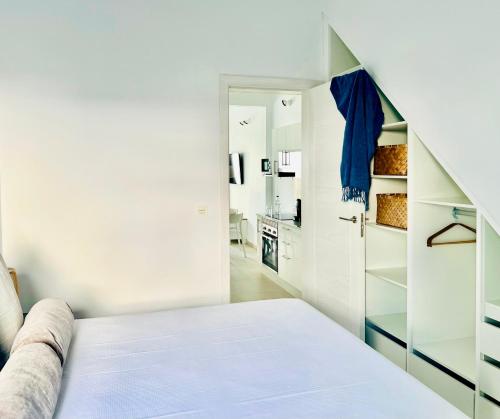 a white bedroom with a bed and a closet at Canaryislandshost l Cala in Punta de Mujeres