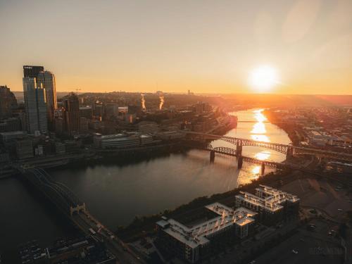 a view of a city with a river and a bridge at Southwest Charming Apartment - Amazing View in Pittsburgh