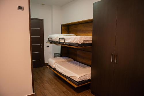 a room with two bunk beds and a closet at ARTEMIDE "Fiore Club" B&B SUITE SPA in Giffoni Valle Piana