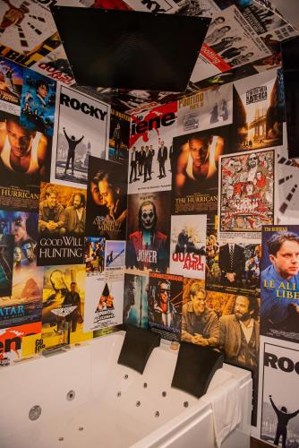a bunch of movie posters on a wall at ARTEMIDE "Fiore Club" B&B SUITE SPA in Giffoni Valle Piana