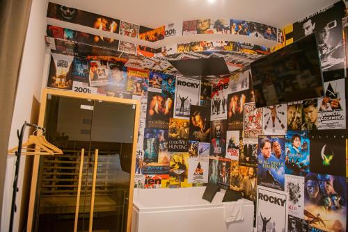 a room with a wall covered in movie posters at ARTEMIDE "Fiore Club" B&B SUITE SPA in Giffoni Valle Piana