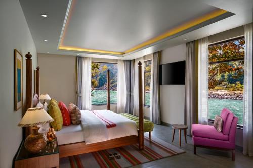 a bedroom with a bed and a large window at Anand Kashi by the Ganges Rishikesh - IHCL Seleqtions in Rishīkesh