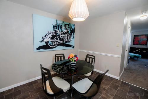 a dining room with a table with chairs and a motorcycle on the wall at The Andrew and Andy on Mt Washington in Pittsburgh