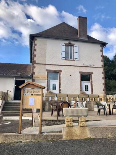 a building with tables and chairs in front of it at Appartement Les Bons Vivants au coeur de Perrigny in Perrigny-sur-Loire