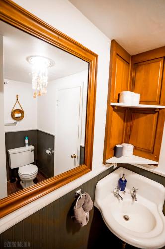 a bathroom with a sink and a mirror and a toilet at The George Washington on Mt Washington in Pittsburgh
