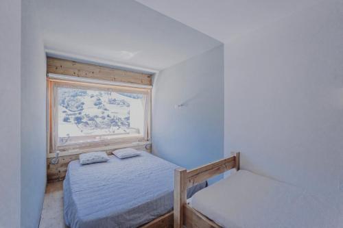 a bedroom with two beds and a painting on the wall at Appartement centre village rénové, 6 personnes, 2 chambres - CL2D in Beaufort