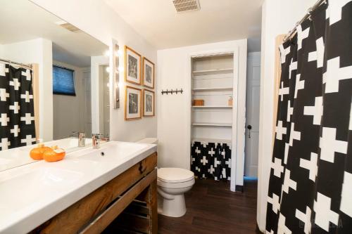 a bathroom with a sink and a toilet at The Peak Mt Washington - Large 2bd Apt w A View in Pittsburgh
