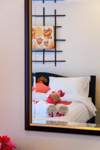 a reflection of a bed in a mirror at Swiss Paradise Boutique Villa in Pattaya North