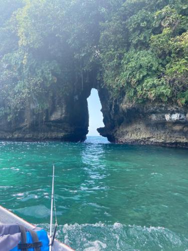 a boat in the water in front of a cave at The Lodge at Punta Rica- Hilltop Eco-Lodge with Views & Pool in Bastimentos