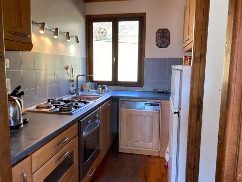 a kitchen with a sink and a stove top oven at Chalet vue panoramique, 11 personnes, 5 chambres - CH47 in Beaufort