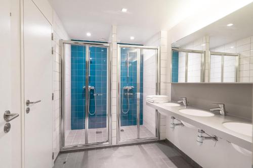 a bathroom with two sinks and a shower at FIAP Paris in Paris