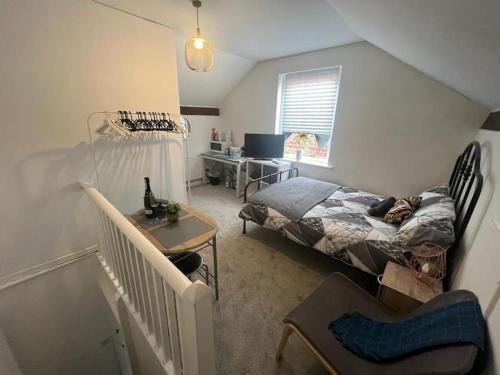 a bedroom with a bed and a desk in it at Sleeps up to 8 Free Parking Large Town House 3 Bed, 2 Bathrooms Private Locked Garden In-between Nottingham & Derby Contractor Friendly in Ilkeston