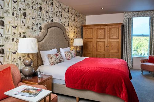 a bedroom with a bed with a red blanket at Hotel du Vin Cheltenham in Cheltenham