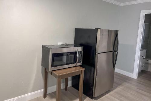 a microwave on a table next to a refrigerator at Marco Island Lakeside Inn in Marco Island