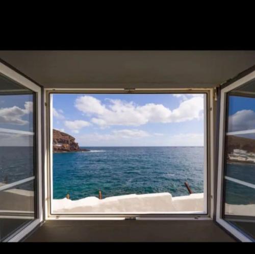 a window on a boat looking out at the ocean at Neptuno OceanFront in Telde