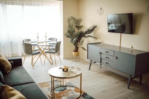 a living room with a blue cabinet and a table at Apartament Ploiesti Central in Ploieşti