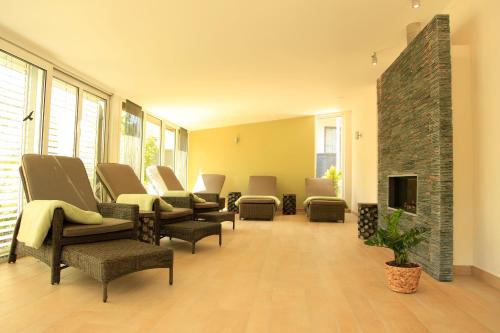 a waiting room with chairs and a fireplace at Flair Hotel Nieder in Bestwig