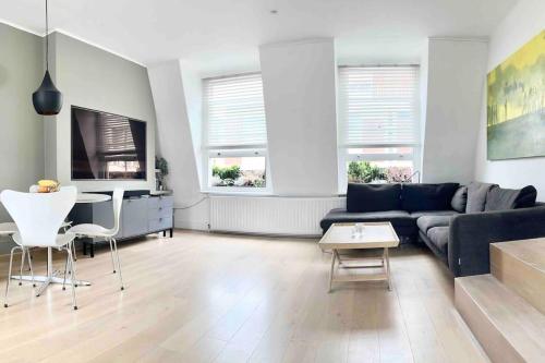 a living room with a couch and a table at Stunning Central London flat 1 min Bond Street in London