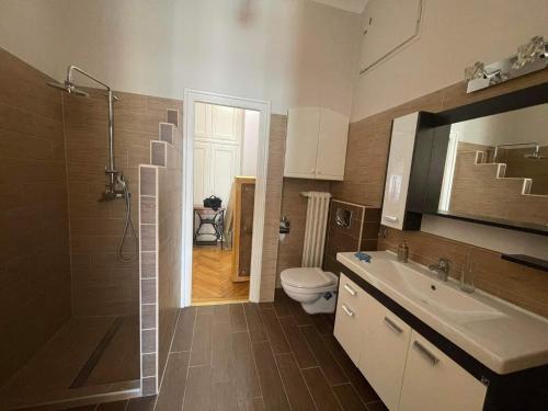 a bathroom with a shower and a toilet and a sink at Marietta in Debrecen