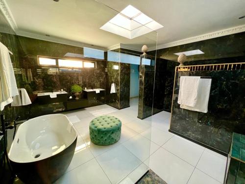 a large bathroom with a sink and a tub at Forty 4 On Hoog in Polokwane
