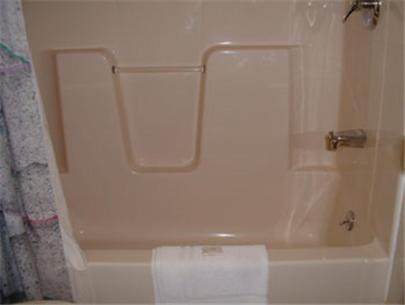 a bathroom with a bath tub with a towel at Wagon Wheel Inn in Lenox