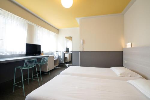 מיטה או מיטות בחדר ב-FIAP Paris