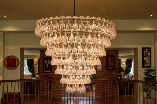 a large glass chandelier hanging from a ceiling at Hotel du Vin Cheltenham in Cheltenham