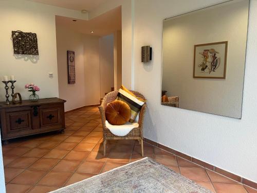 a living room with a chair and a mirror at Hof Dalhaus in Lüdinghausen