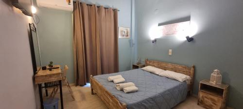 a bedroom with a bed with towels on it at Corfu-Apartments4you in Acharavi