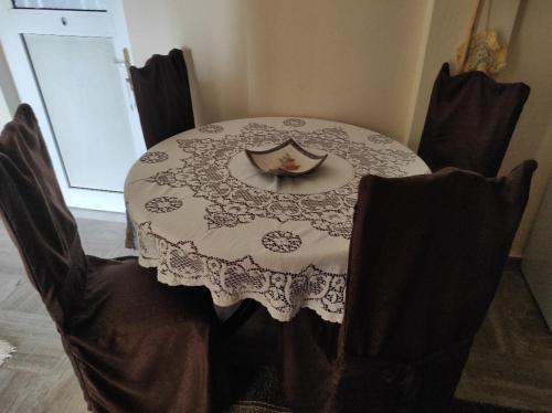 a dining room table with a lace table cloth on it at NASOS APARTMENT METEORA in Kalabaka