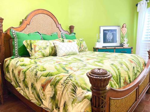 a bedroom with a large bed with green walls at Riverfront condo downtown newbraunfels in New Braunfels