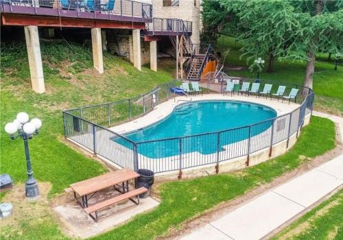 an overhead view of a swimming pool with a bench at Riverfront condo downtown newbraunfels in New Braunfels