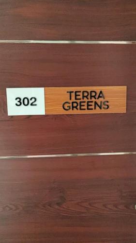 a wooden door with a sign that says terra greenres at Magni Home in Cochin