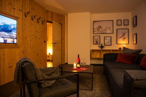 a living room with a couch and a table at bergfried - Designwohnung mit Weitblick in Fulpmes