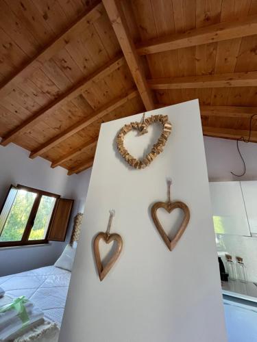 a bedroom with two hearts hanging on a wall at Casa Gil, Quinta Carmo - Alcobaça/ Nazaré in Alcobaça