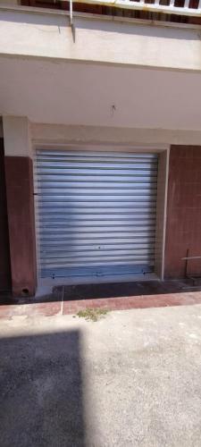 a garage with a large garage door on a building at Le Stanze di Maria-Ingresso Autonomo Maria's Rooms-Indipendent Entrance in Giovinazzo