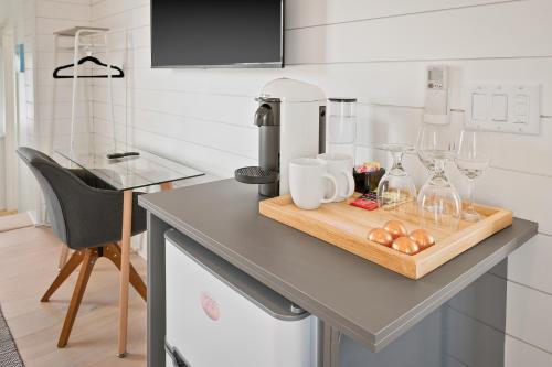 a kitchen counter with wine glasses on a cutting board at Boutique Room steps from Downtown Mall Rose Jean - Room 4 in Charlottesville
