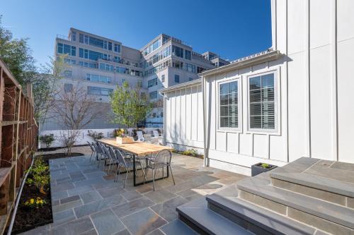 a patio with a table and chairs and a building at Boutique Room steps from Downtown Mall Rose Jean - Room 4 in Charlottesville