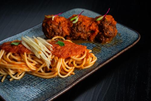a plate of food with spaghetti and meatballs at Laghetto Stilo São Paulo in Sao Paulo