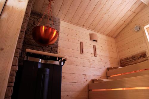 a room with a wooden ceiling and a hanging light at Flair Hotel Nieder in Bestwig