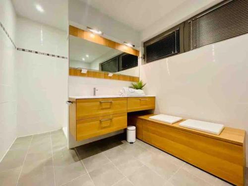 a bathroom with a sink and a mirror at Villa d’architecte avec piscine chauffée in Ligny-en-Cambrésis