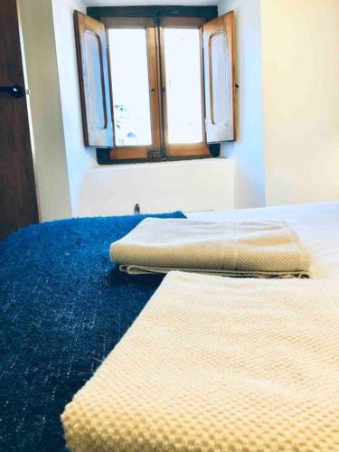 a bedroom with two beds and a window at La Cabañita de Llívia, Cerdanya, Puigcerdà in Llivia