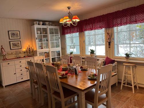 una sala da pranzo con tavolo e sedie in legno di Cozy house close to SantaVillage a Rovaniemi