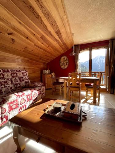 a living room with a couch and a table at T3 Champagny-en-Vanoise avec terrasse plein sud in Champagny-en-Vanoise