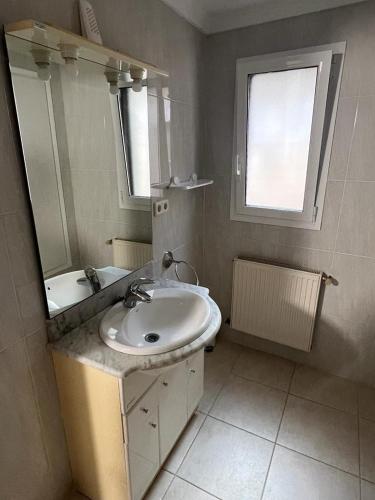 a white bathroom with a sink and a mirror at apartament la cova in Peralada