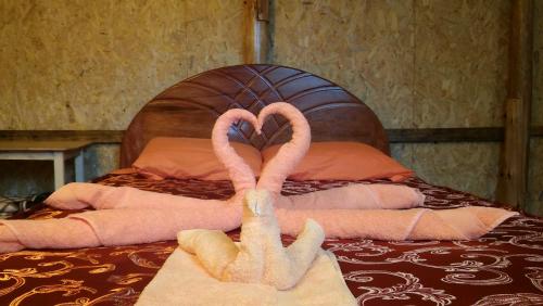 two towel flamingos sitting on top of a bed at Refugios Salkantay - "StaySoraypampa - Accommodation near Humantay Lake and Salkantay Trek" in Cusco