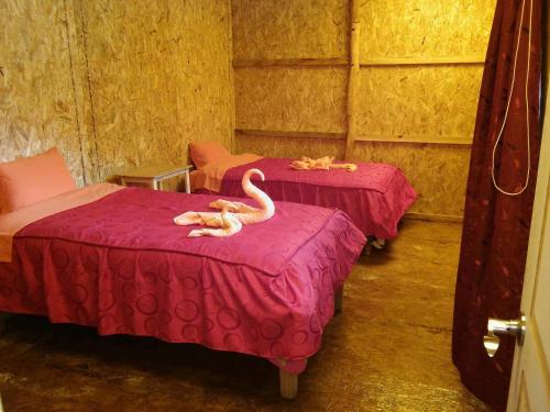 a room with two beds with animals on them at Refugios Salkantay - "StaySoraypampa - Accommodation near Humantay Lake and Salkantay Trek" in Cusco